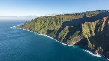 A tourist helicopter crashes off the coast of a Hawaiian island, resulting in the death of one person and the disappearance of two others.