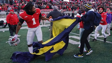 A massive brawl at midfield breaks out during Michigan's shocking upset over Ohio State, causing chaos.