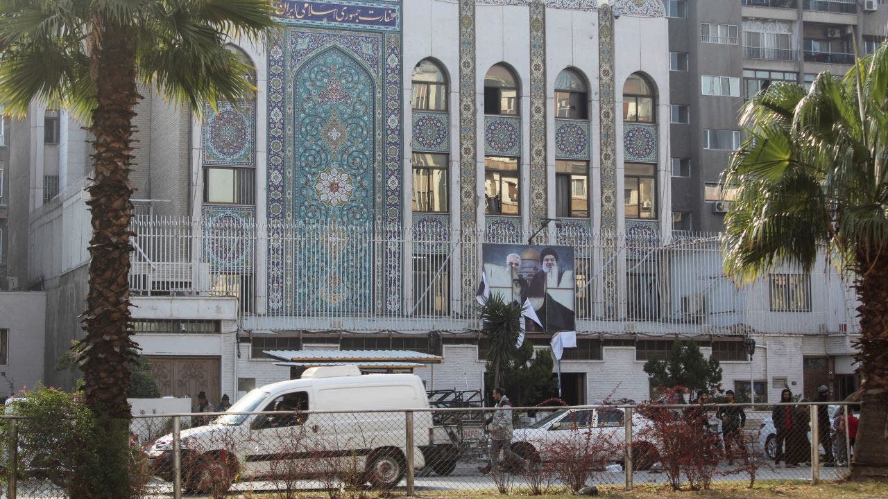 As Russia claims that Assad gave orders to transfer power, gunmen attack the Iranian embassy in Damascus.