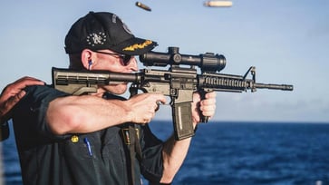 US Navy warship commander removed from command after photo of him using rifle with scope mounted backward.