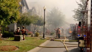 One resident is missing after a small plane with two people on board crashes into townhouses in Oregon.