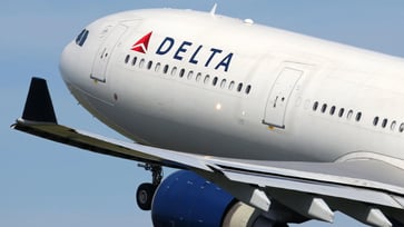 Passengers on Delta flight evacuate using emergency slides during aborted takeoff.