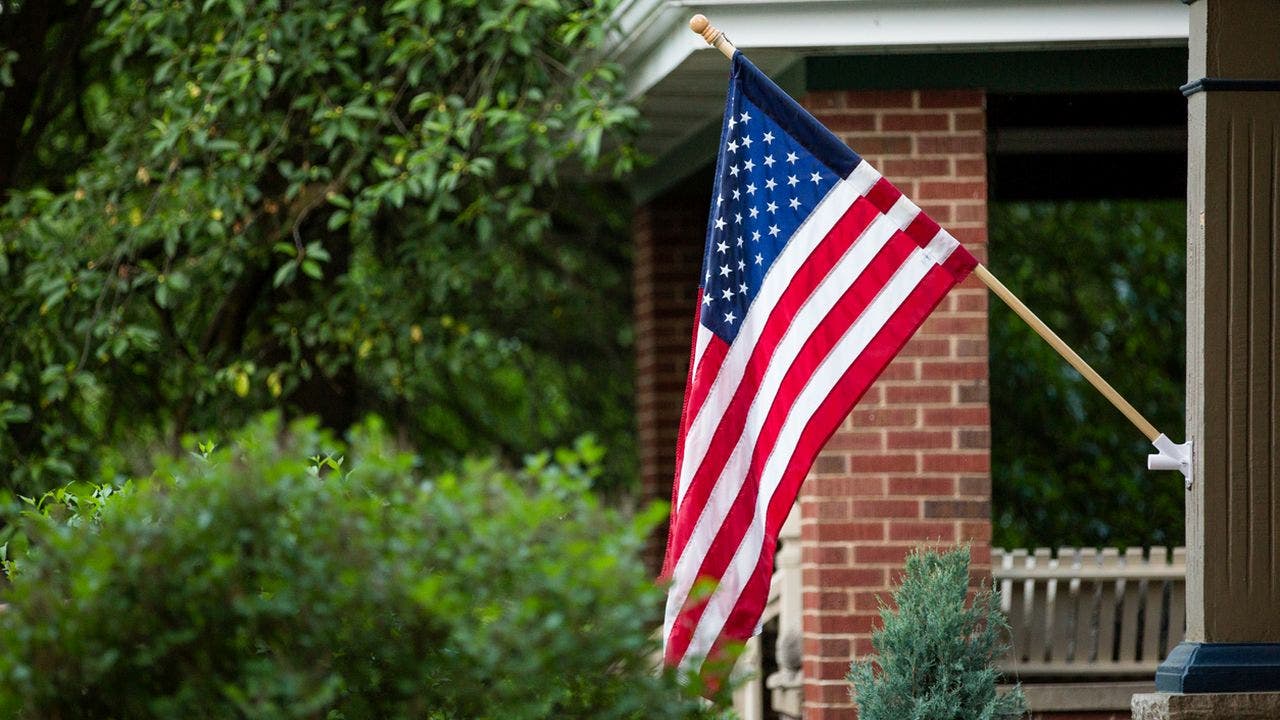 A New Jersey lawyer was removed from a town council meeting after waving an American flag in protest of a new ban.