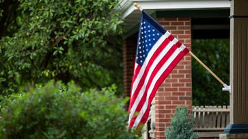 A New Jersey lawyer was removed from a town council meeting after waving an American flag in protest of a new ban.