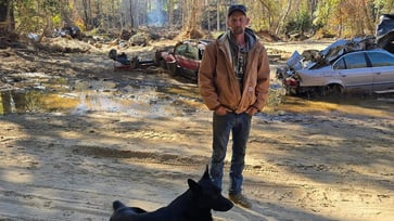 After Hurricane Helene, a North Carolina man had to rebury his father's casket on the property where he was sleeping in a tent.