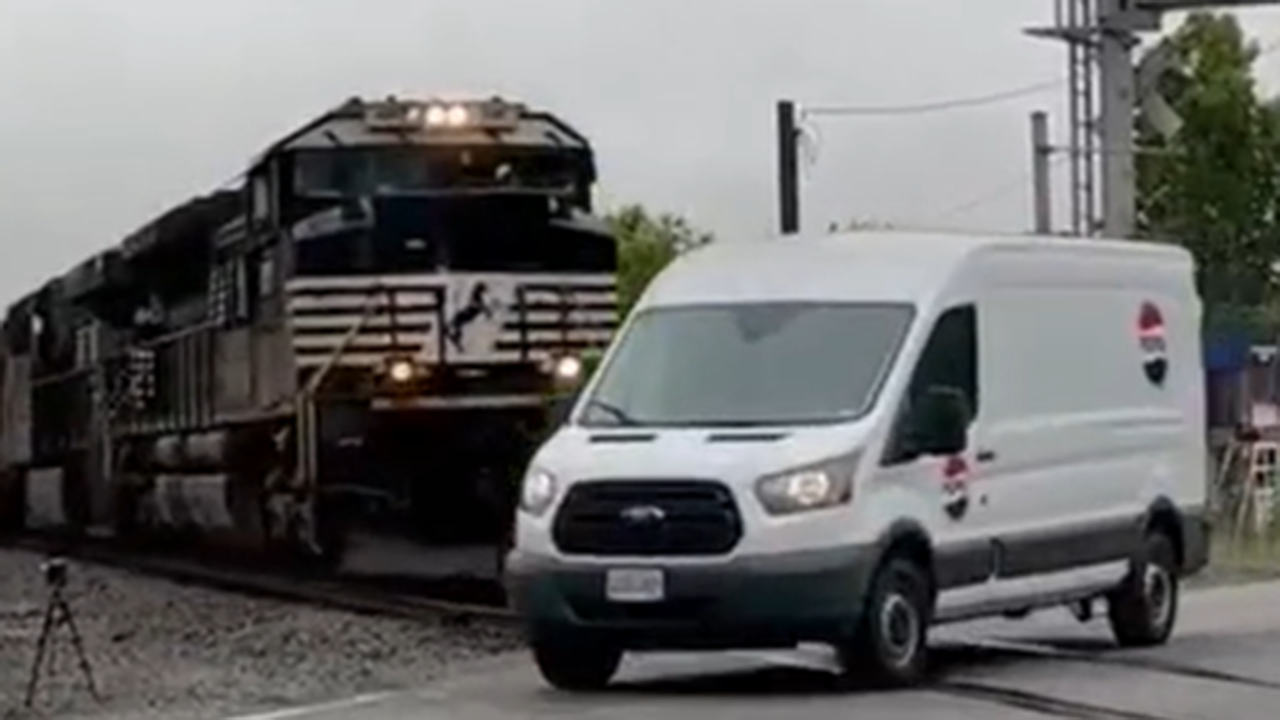 Video shows van barely escaping collision with incoming train.