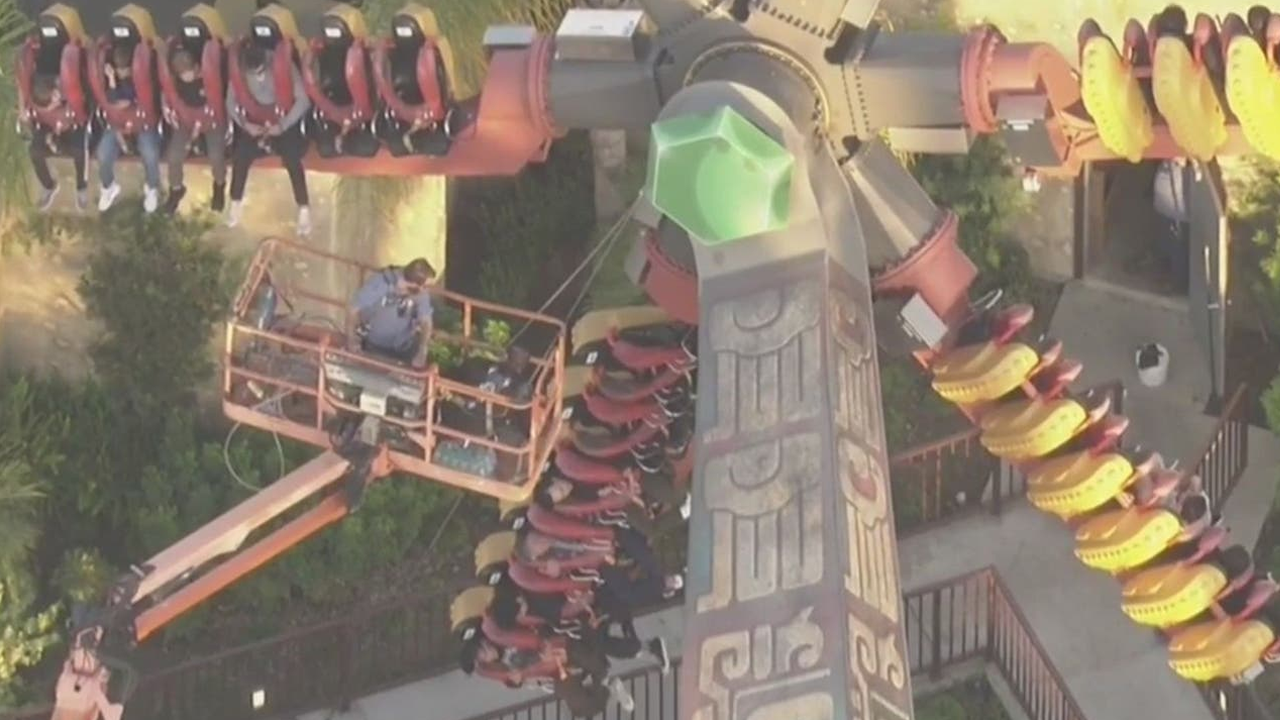 Video footage shows riders suspended in midair on a California amusement park ride.