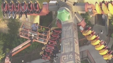 Video footage shows riders suspended in midair on a California amusement park ride.