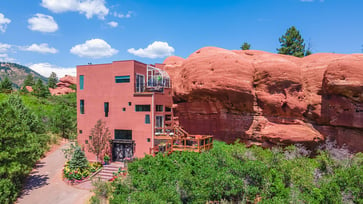 A Colorado home built into 200 million-year-old red rocks is now available for purchase, offering a unique indoor-outdoor living experience.