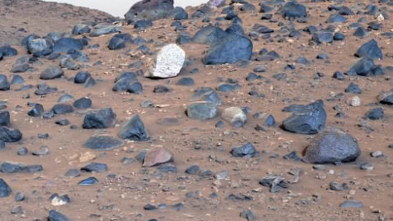 NASA unveils the clearest image of Mars, showcasing blue rocks on the Martian terrain.