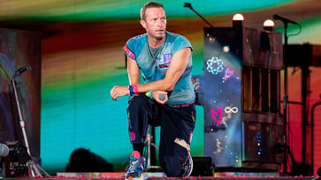 Chris Martin, the lead singer of Coldplay, accidentally falls through a trapdoor while performing on stage in Australia.