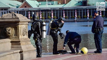 The manhunt for the CEO's killer continues as NYPD divers search Central Park lake.