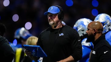 Dan Skipper, a member of the Lions team, is acknowledged by Dan Campbell during his impassioned postgame victory speech as he vomits.