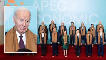 Biden is positioned behind Xi Jinping in the APEC photo.