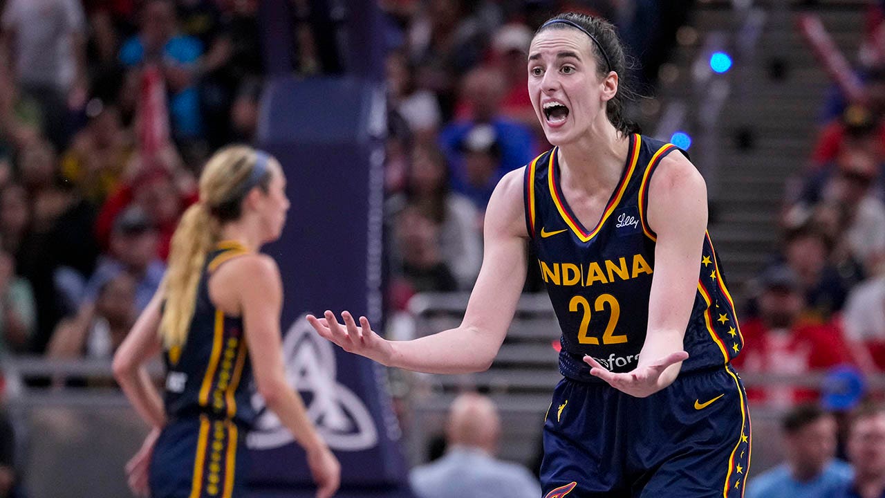 Caitlin Clark's teammates prevent her from getting a technical foul.