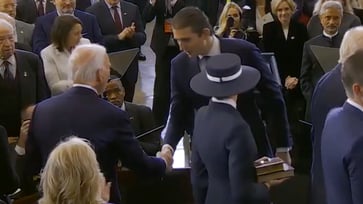 Barron Trump stirs up social media by shaking hands with Biden at his father's inauguration.