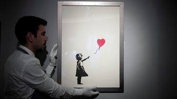 Two individuals have been charged following the theft of Banksy's 'Girl with Balloon' from a London art gallery.