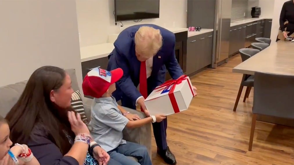 Trump encounters young admirer with unusual brain condition behind the scenes at rally.